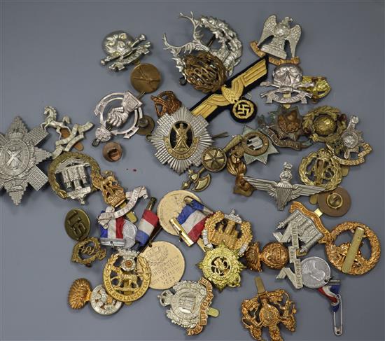 A collection of military cap badges etc.